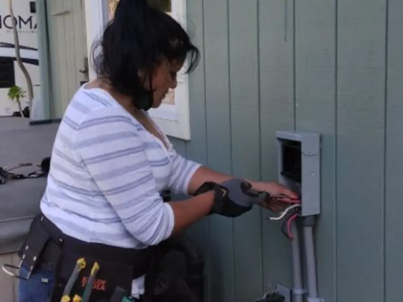 Licensed electrician wiring an exterior subpanel in Lesslie