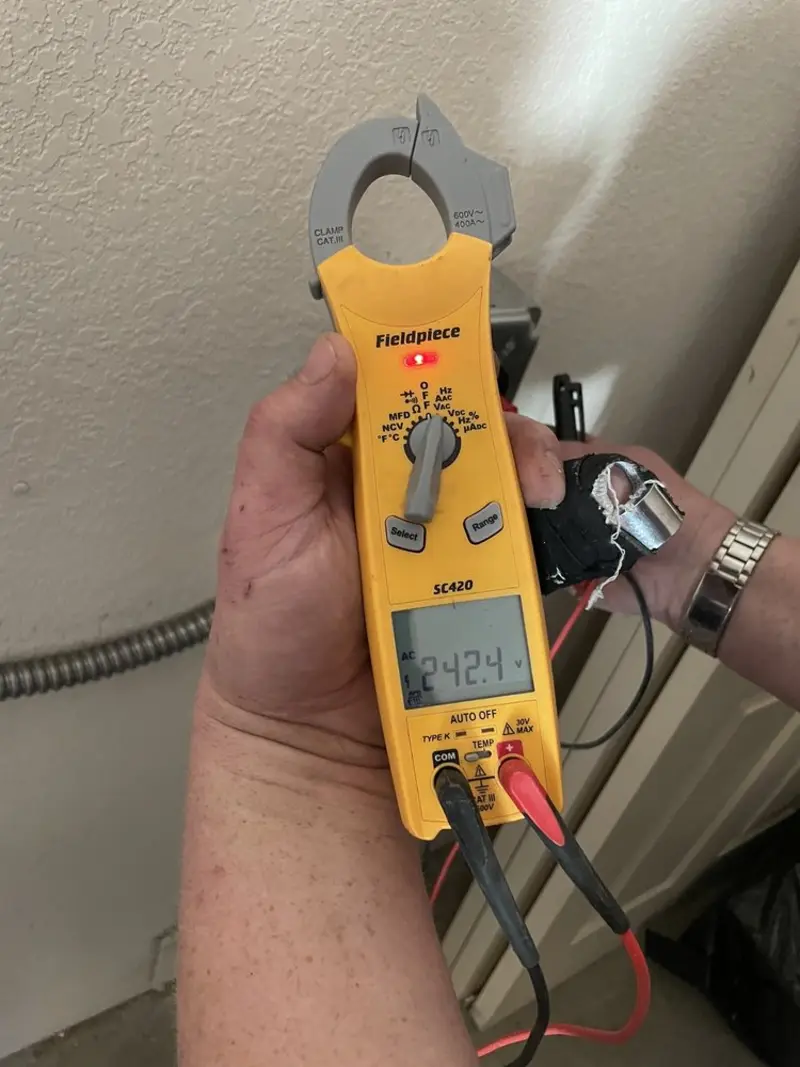 Voltage testing with clamp meter during Electrical Installation Services in Lesslie